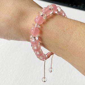 Pink and clear glass beaded cord bracelet.